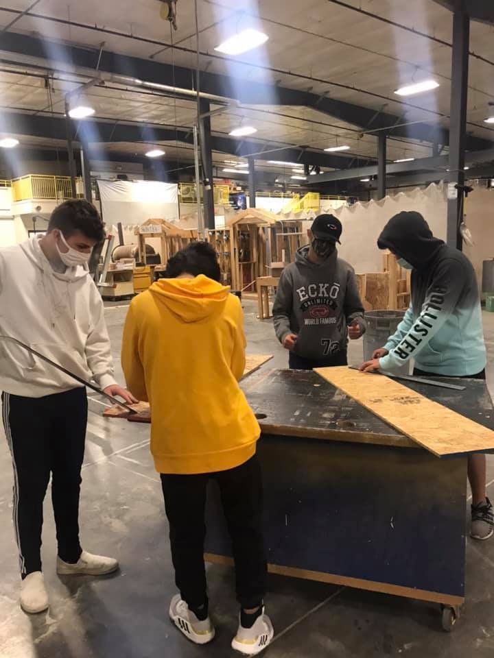 Students measuring wood.