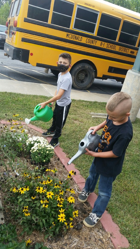 Kids watering garden